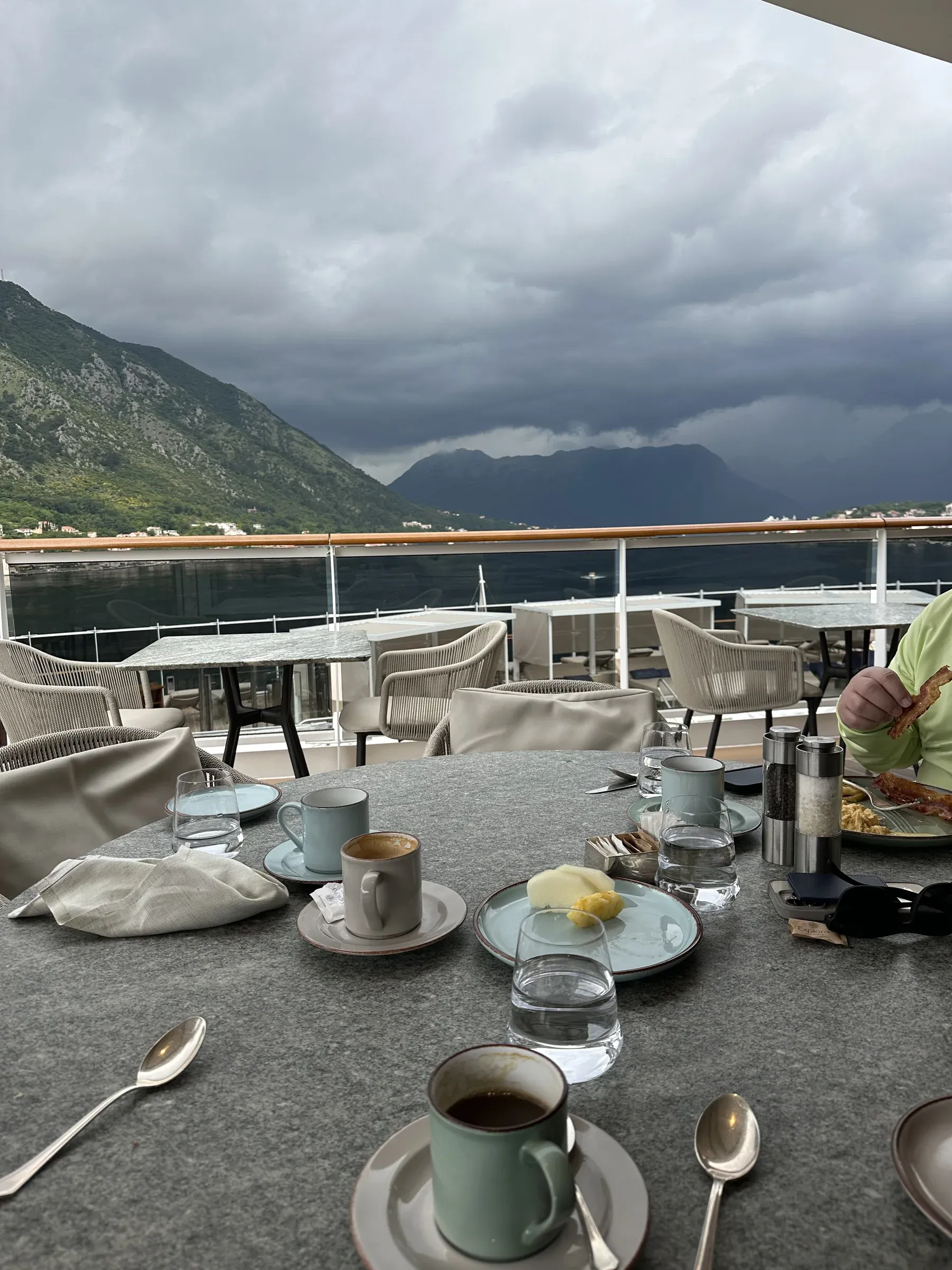 Open-deck dining tables set over the sea aboard Explora I