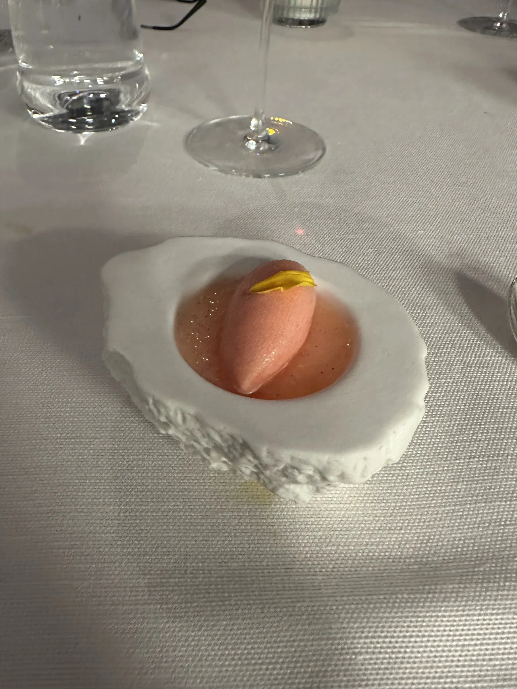 A composed dessert plated on white at dinner aboard Explora I