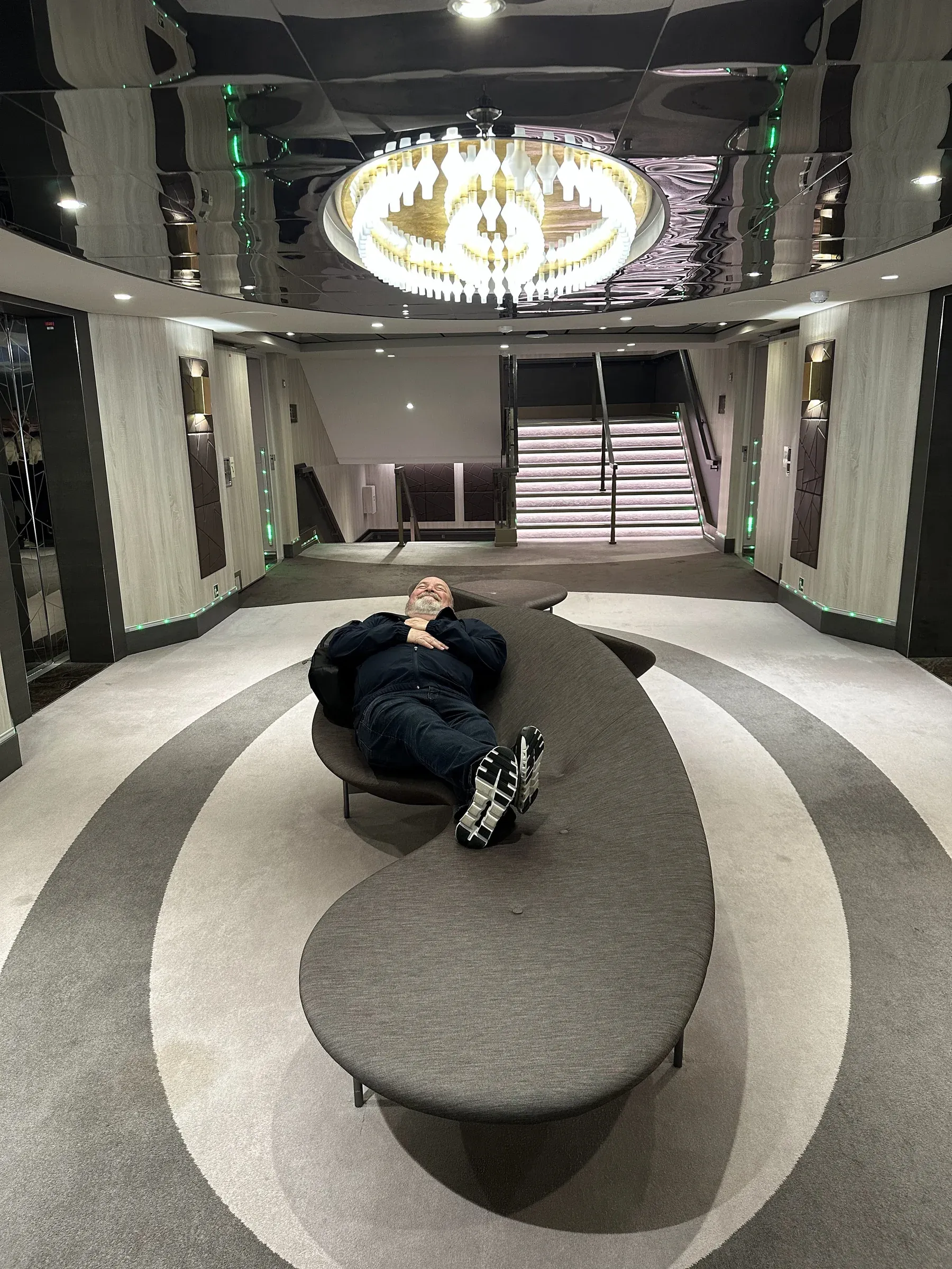 Me in Explora I's atrium beneath its sculptural disc chandelier