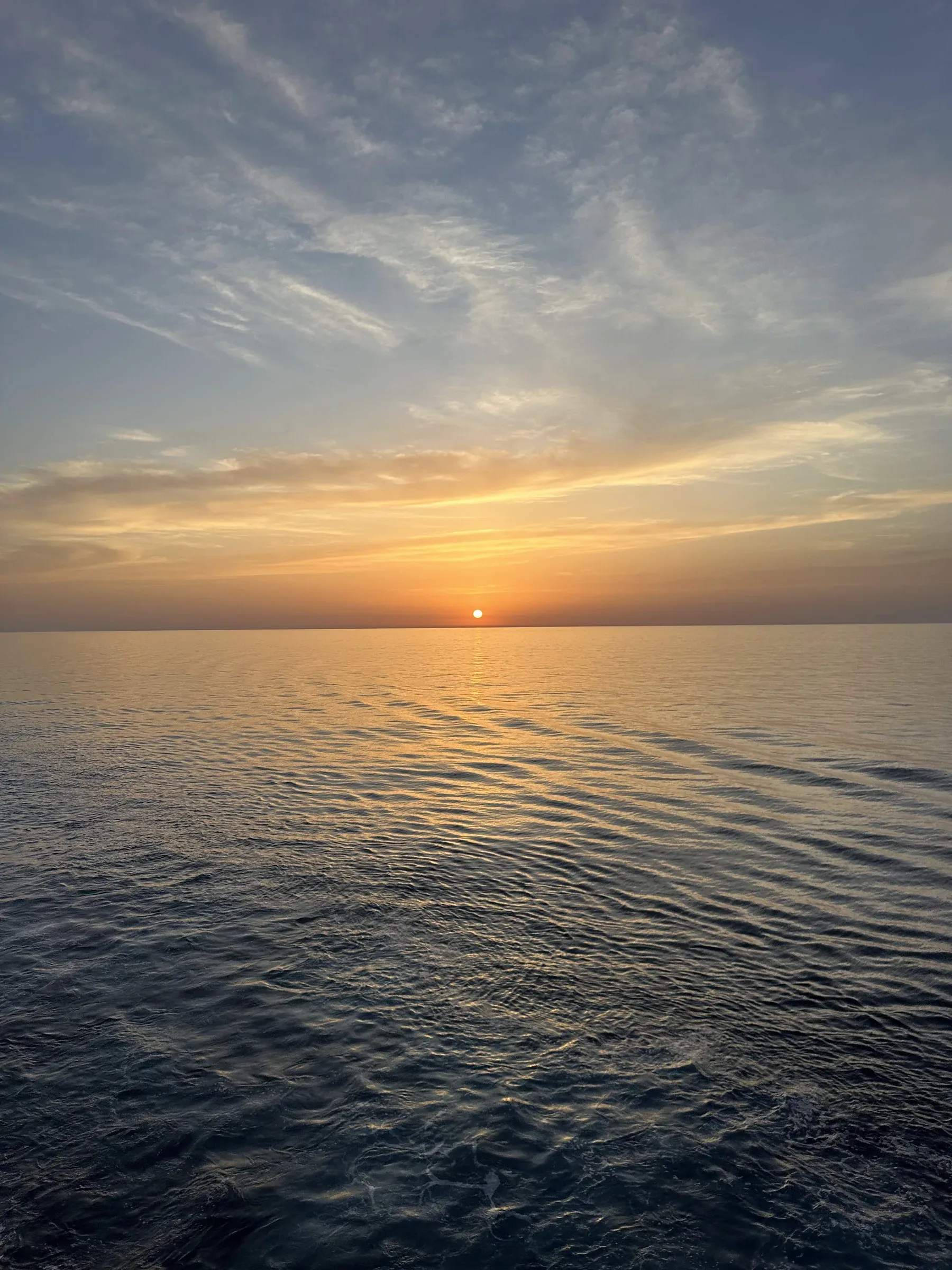 A gold sunset over a calm Mediterranean from the deck of Explora I