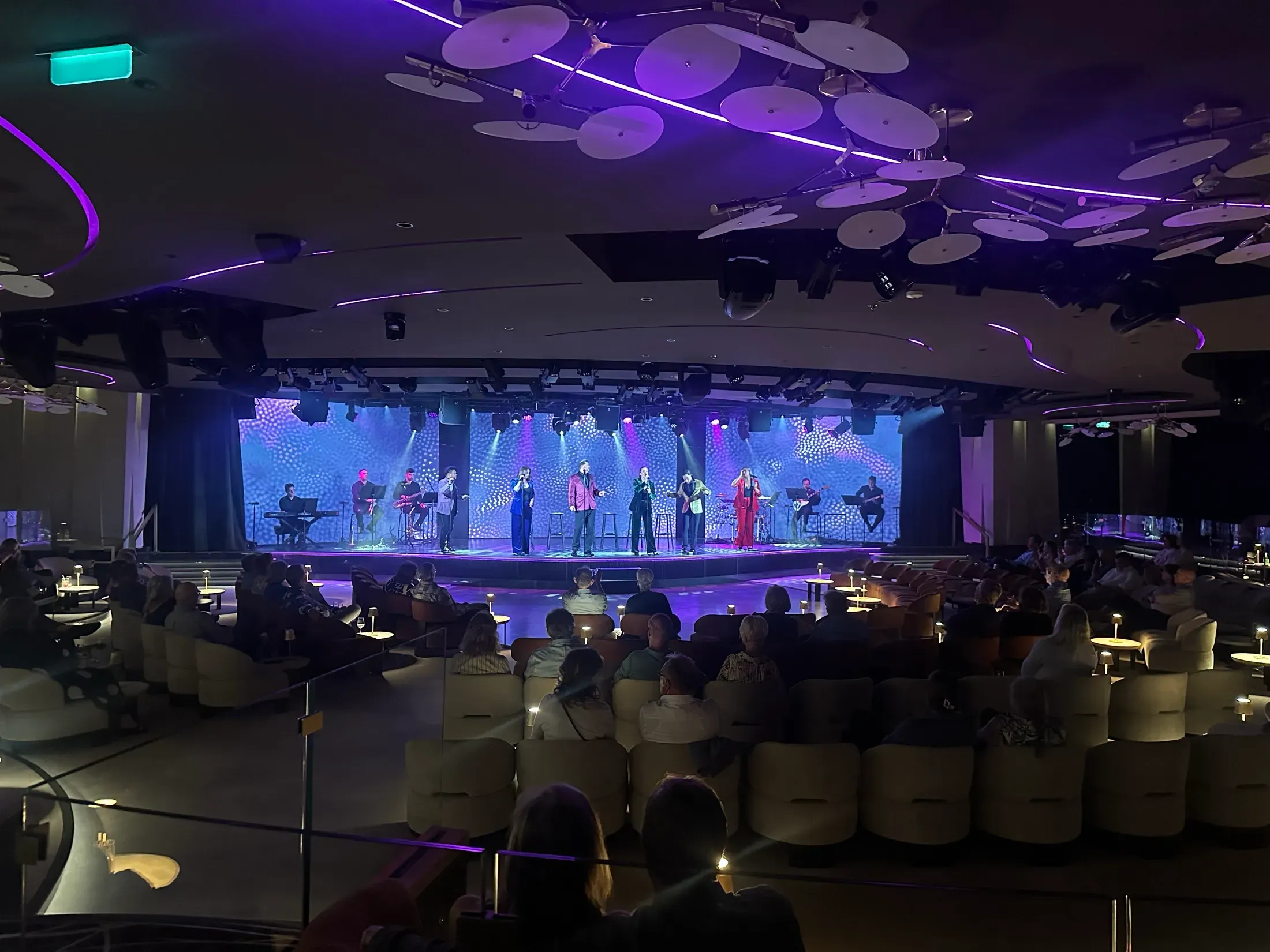 A nightly production show on the Explora I stage, the theater's disc-chandelier ceiling overhead