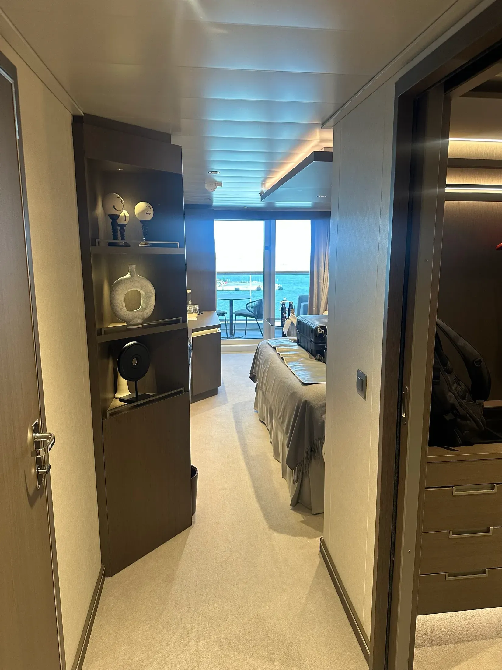The interior of my Explora I suite: design-led shelving, a made bed, and a private terrace over the water