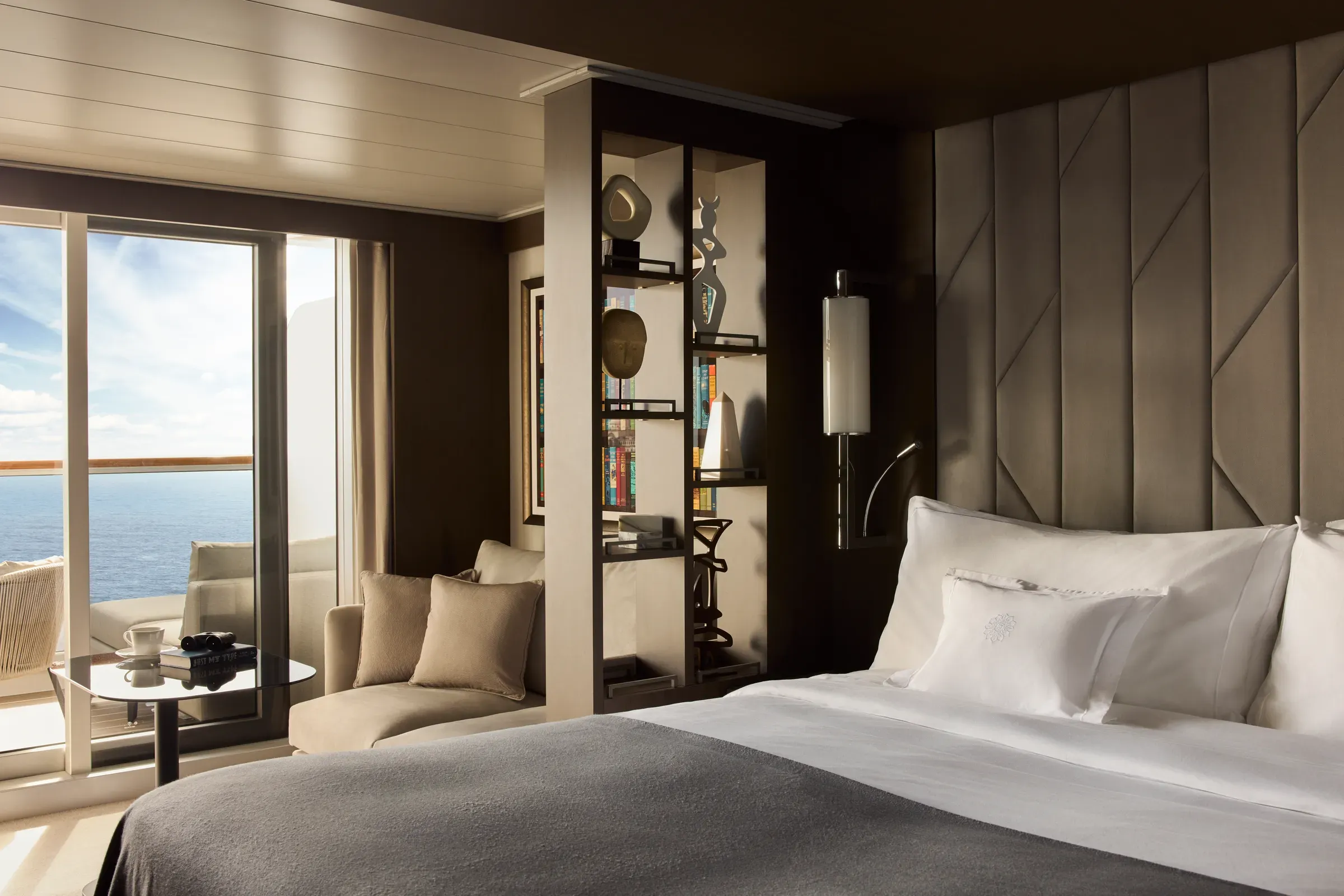 An Explora Ocean Terrace Suite interior with floor-to-ceiling windows and a private terrace