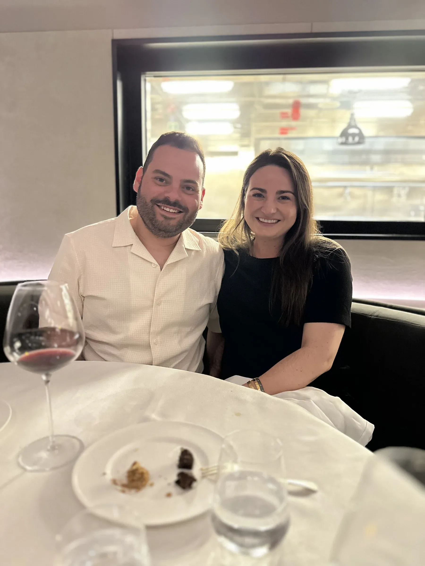My wife and me at dinner aboard Explora I, the sea through the windows behind us